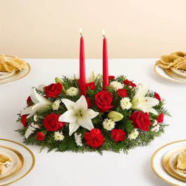 Red and white floral centerpiece with two red candles
