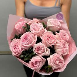 Bouquet of pale pink roses wrapped in pink paper