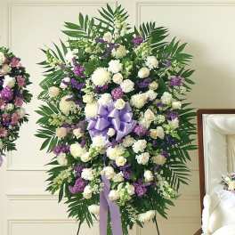 Large white and purple funeral spray with a lavender ribbon