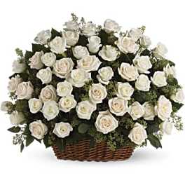 White rose arrangement in a wicker basket