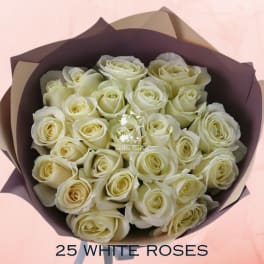 Bouquet of white roses wrapped in dark paper