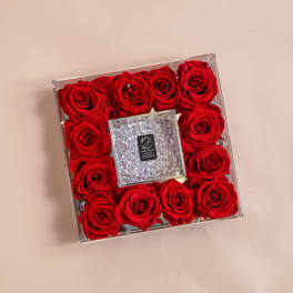 Square box of red roses with a clear jeweled center