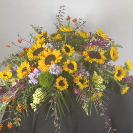Large floral spray with sunflowers and purple blooms