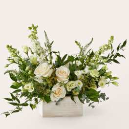 White roses and green-white flowers arranged in a rectangular wooden box