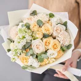 Bouquet of cream and peach roses with white filler flowers