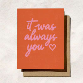 Orange greeting card with pink text reading "it was always you" and a heart
