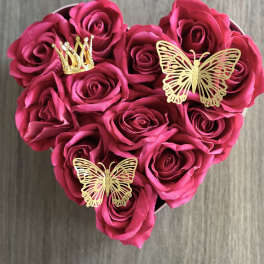 Heart-shaped bouquet of pink roses with gold butterfly and crown picks