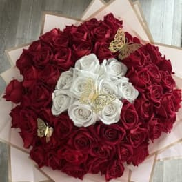 Bouquet of red and white roses with butterfly accents