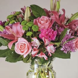Pink and purple mixed bouquet in a clear glass vase