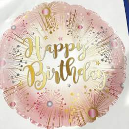 Round pink and gold Happy Birthday balloon with sparkler-style bursts around the edge