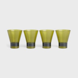 Four yellow-green drinking glasses on a white background