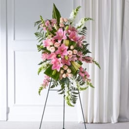 Pink floral standing spray on a black easel