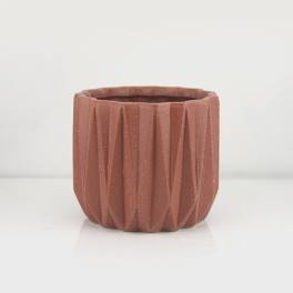 Textured terracotta-colored planter pot on a white background