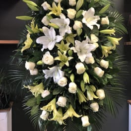 Large standing floral spray with white lilies and cream roses