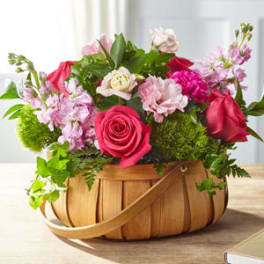 Basket of pink and red roses with mixed flowers