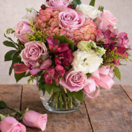 Pink and white rose bouquet in a clear glass vase