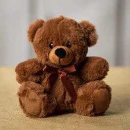 Brown teddy bear with a ribbon bow