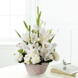 White floral arrangement in a woven basket
