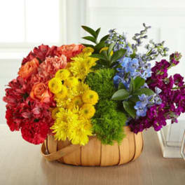 Colorful mixed flower arrangement in a woven basket
