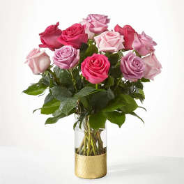 Bouquet of pink and lavender roses in a clear glass vase