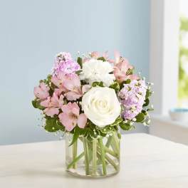 Pink and white bouquet in a clear glass vase