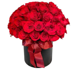 Red rose bouquet in a black box tied with a red ribbon