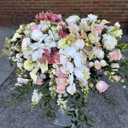 Large bouquet of white and pink flowers with cascading greenery