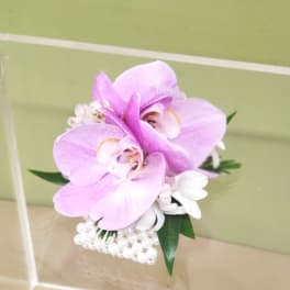 Pink orchid corsage with white accents and pearl trim