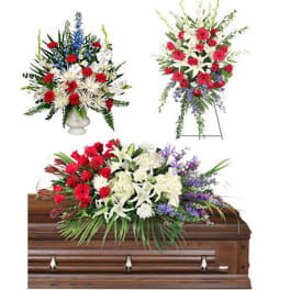 Floral casket spray with red, white, and purple flowers