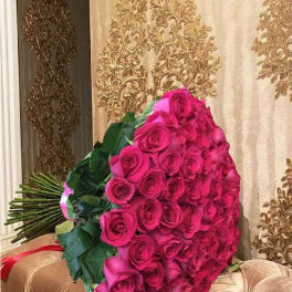 Large bouquet of hot pink roses with dark green foliage