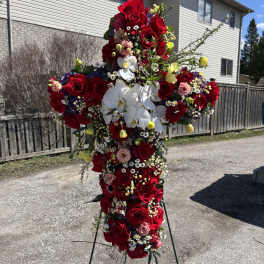 Large cross-shaped floral spray with red roses and white orchids