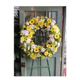 Yellow and white floral wreath on an easel