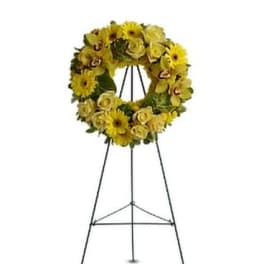 Yellow floral wreath on a black standing easel