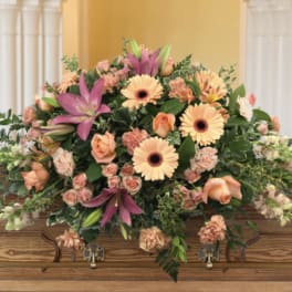 Large casket spray with peach and pink flowers