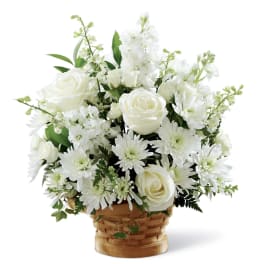 White roses and daisies arranged in a woven basket