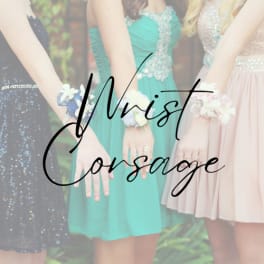 Three women in dresses wearing floral wrist corsages