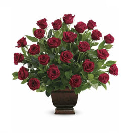 Red roses arranged in a dark pedestal vase