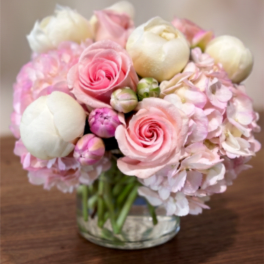 Pink and white bouquet in a clear glass vase