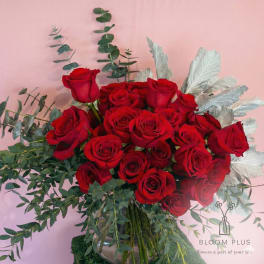 Bouquet of red roses with eucalyptus in a glass vase