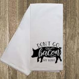White kitchen towel with a black pig graphic and text