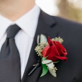 Red rose boutonniere on a black suit lapel