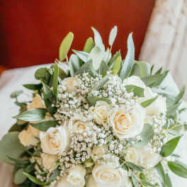 White rose bouquet with baby's breath and greenery