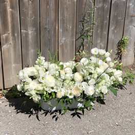 Low white floral arrangement in a rectangular container