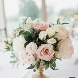 Blush and white rose bouquet in a gold vase