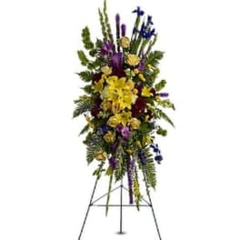Tall standing floral spray with yellow, purple, and blue flowers