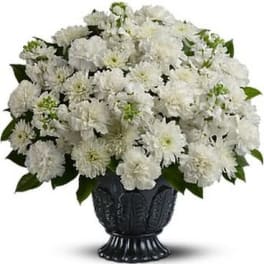 White chrysanthemum bouquet in a black urn vase