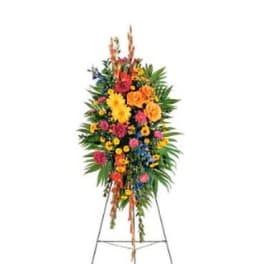 Standing floral spray with bright mixed flowers on an easel