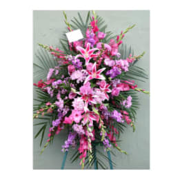 Pink and purple standing floral spray with lilies and carnations