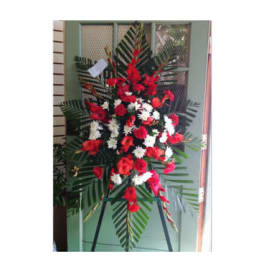Standing floral spray with red and white flowers on an easel