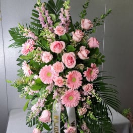 Large pink floral standing spray with roses and gerbera daisies